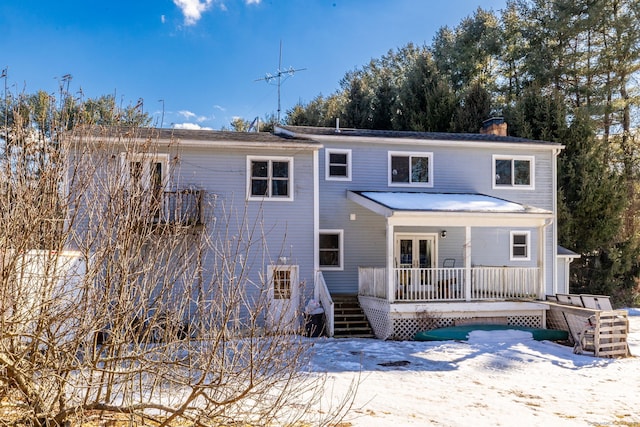 rear view of property featuring french doors and a chimney