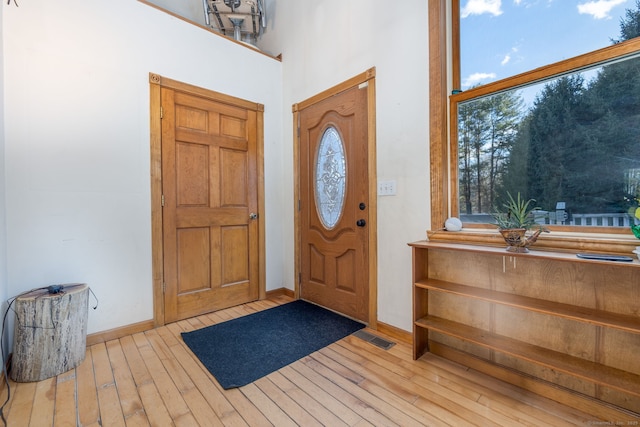 entryway featuring wood-type flooring, visible vents, and baseboards