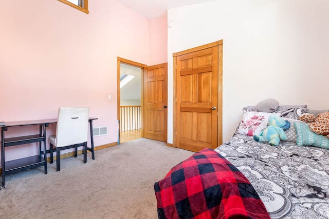 carpeted bedroom with baseboards, a high ceiling, and visible vents