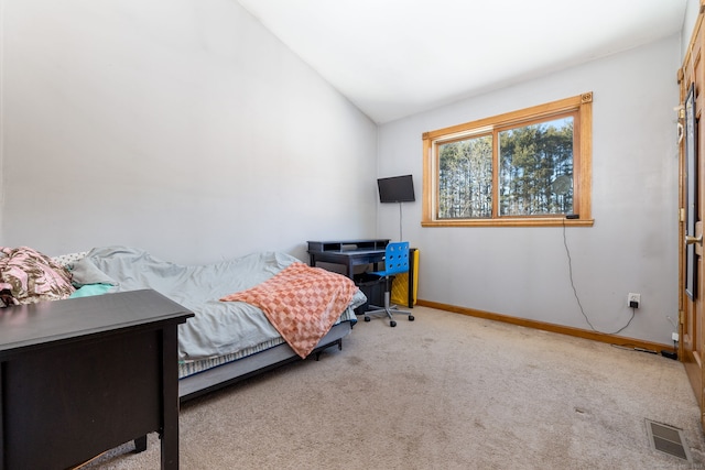 carpeted bedroom with visible vents, vaulted ceiling, and baseboards