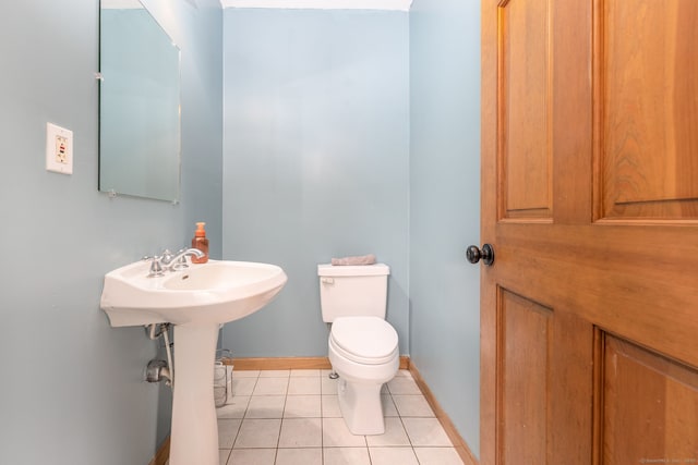 bathroom featuring baseboards, toilet, and tile patterned floors