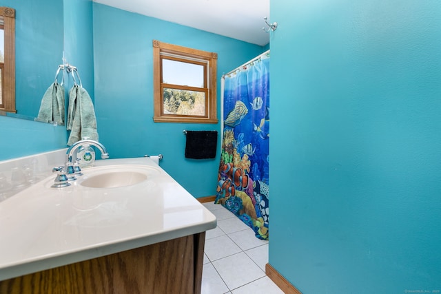 bathroom featuring a shower with curtain, tile patterned flooring, vanity, and baseboards