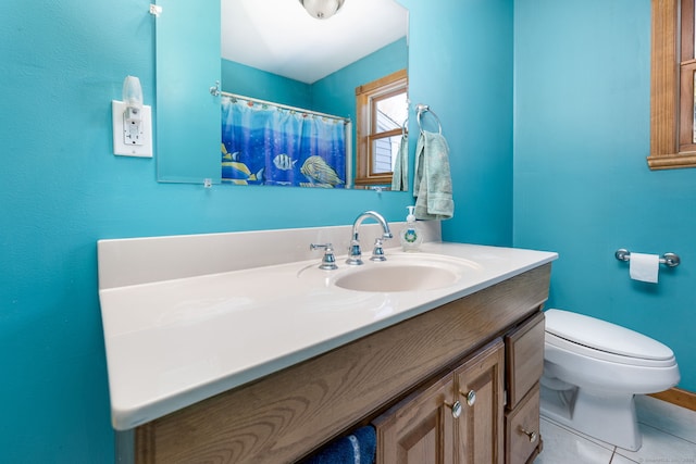 bathroom featuring a shower with shower curtain, vanity, toilet, and tile patterned floors