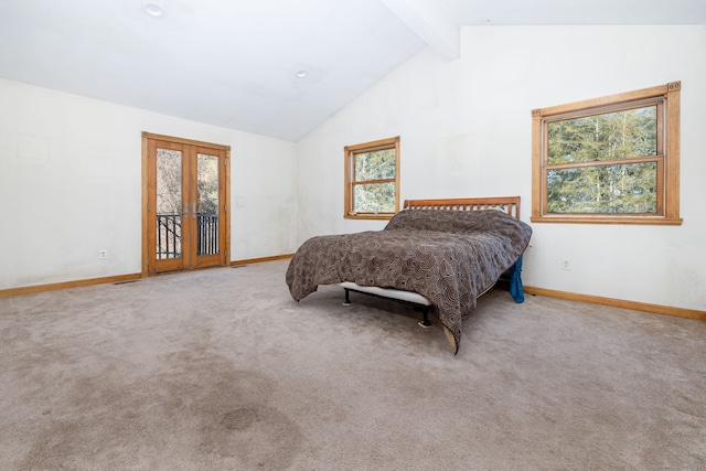 carpeted bedroom featuring lofted ceiling with beams, multiple windows, baseboards, and access to exterior