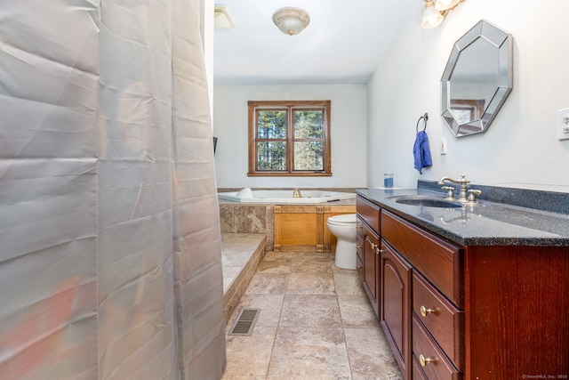 full bath featuring a bath, toilet, vanity, and visible vents