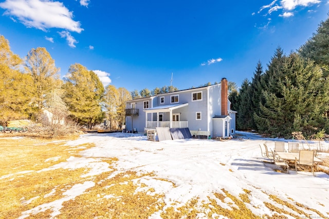 back of property with a chimney