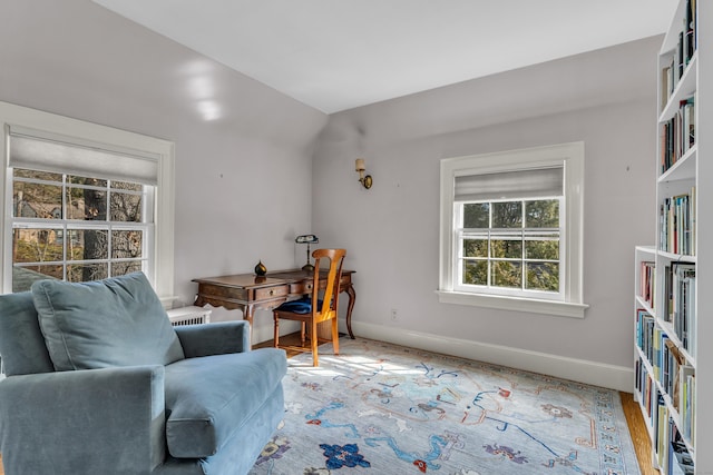 living area featuring baseboards