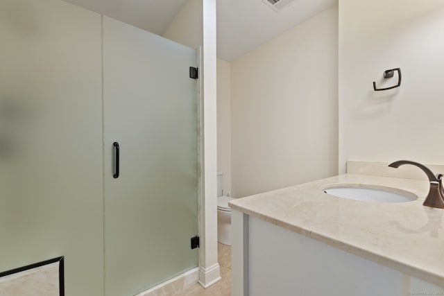 full bathroom featuring toilet, a shower stall, and vanity