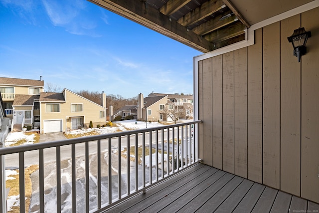 snow covered back of property with a residential view