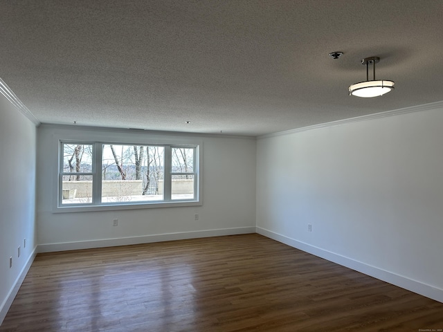 unfurnished room with a textured ceiling, dark wood-style floors, baseboards, and ornamental molding