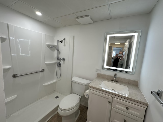 bathroom featuring vanity, toilet, and a shower