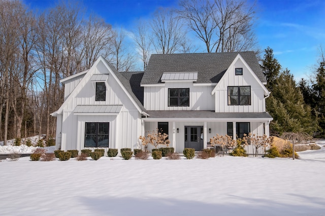 modern inspired farmhouse with a shingled roof, metal roof, a standing seam roof, a porch, and board and batten siding