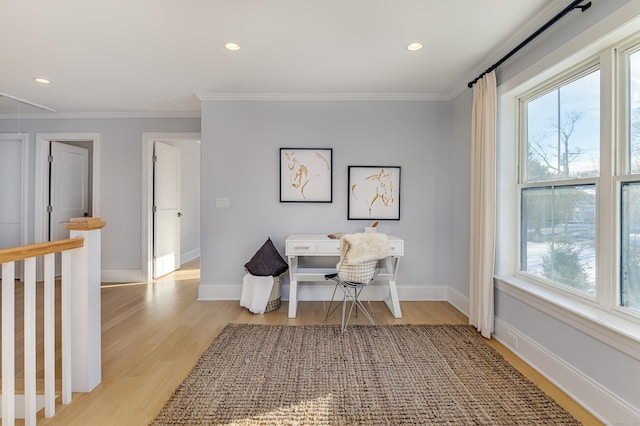 sitting room with light wood-style flooring, ornamental molding, baseboards, and recessed lighting