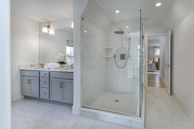 bathroom with a wealth of natural light, marble finish floor, and ensuite bathroom