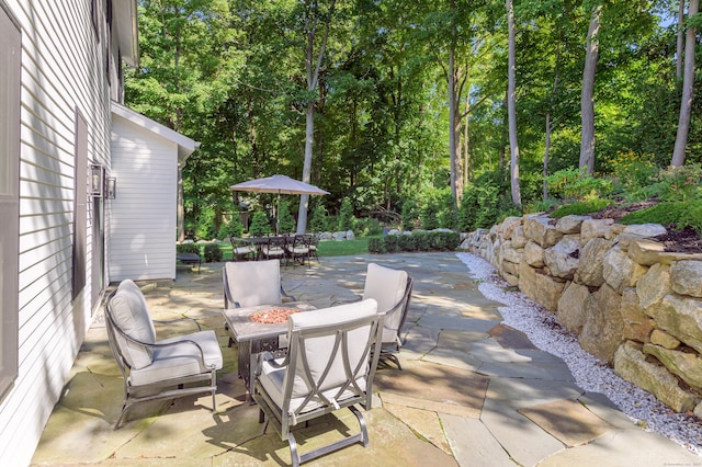 view of patio with a fire pit and outdoor dining space