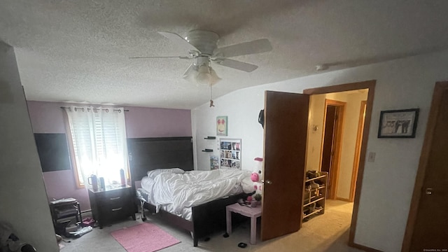 carpeted bedroom featuring ceiling fan, vaulted ceiling, and a textured ceiling