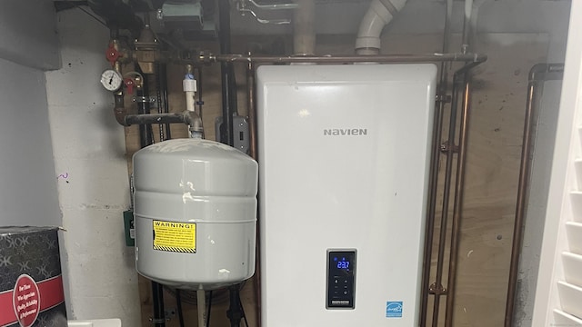 utility room featuring tankless water heater