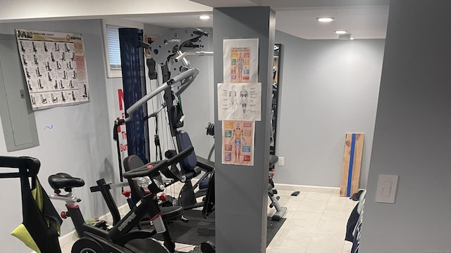 workout area featuring tile patterned flooring and baseboards