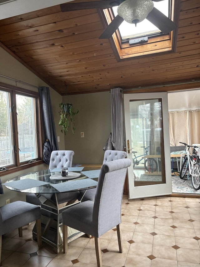 dining room with wooden ceiling, vaulted ceiling with skylight, and light tile patterned floors