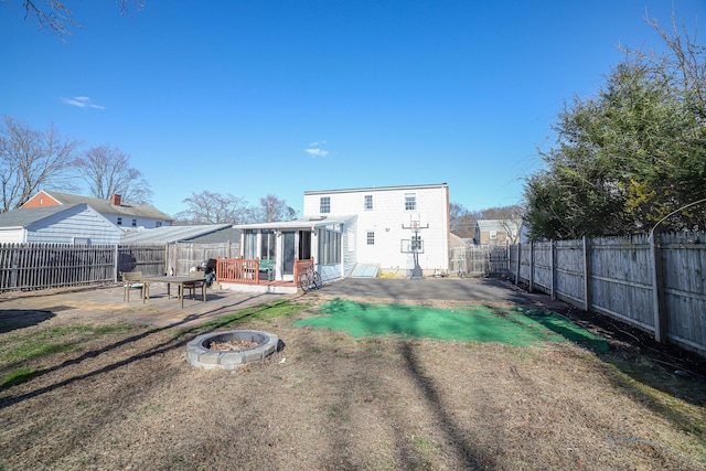 back of house with a patio, a fire pit, and a fenced backyard