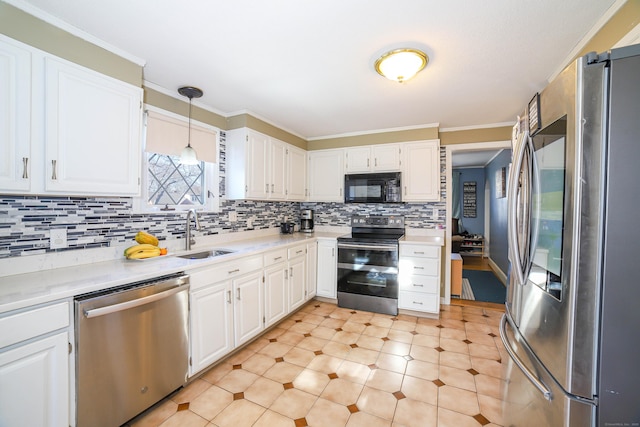 kitchen with a sink, light countertops, appliances with stainless steel finishes, and crown molding