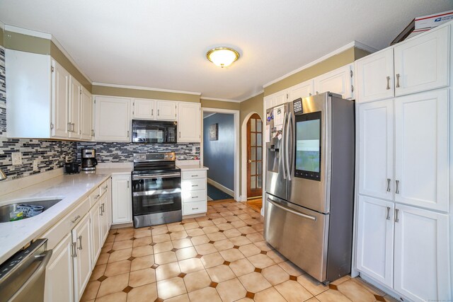 kitchen featuring a sink, ornamental molding, white cabinets, and stainless steel appliances
