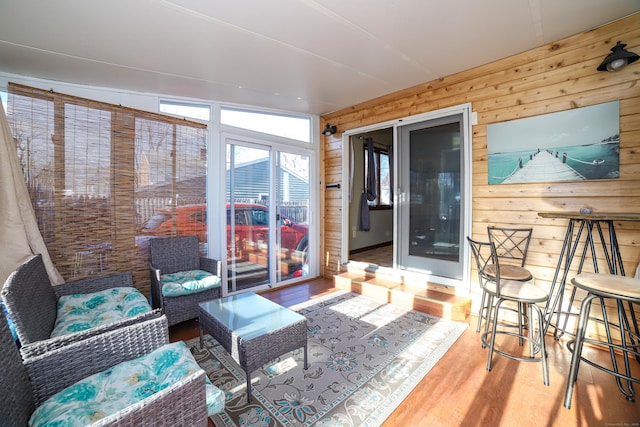 sunroom / solarium with wooden walls and wood finished floors