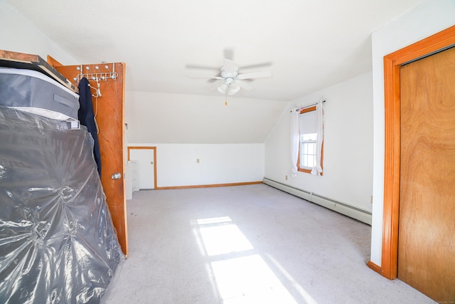 additional living space with baseboards, a baseboard radiator, a ceiling fan, carpet floors, and lofted ceiling