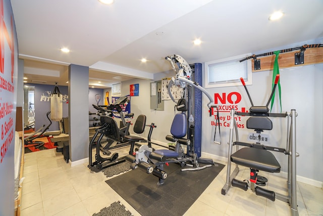 exercise room with baseboards, tile patterned flooring, and recessed lighting