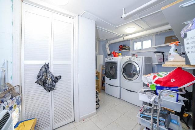 laundry room with independent washer and dryer and tile patterned flooring