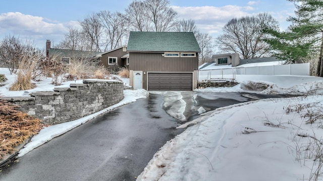 exterior space with driveway and an attached garage