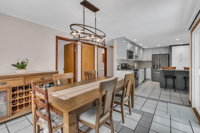 dining space featuring light tile patterned floors, a chandelier, and recessed lighting