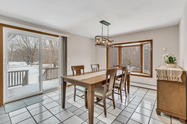 dining room featuring light tile patterned floors, a baseboard radiator, and a notable chandelier