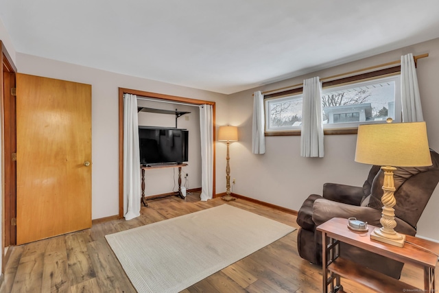 living room featuring light wood-style flooring and baseboards