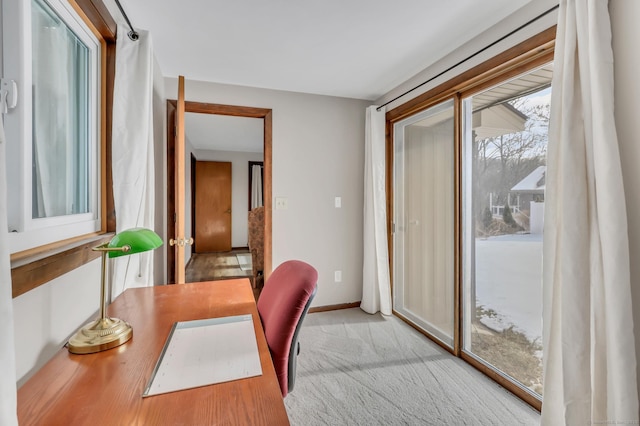 office with light carpet and baseboards