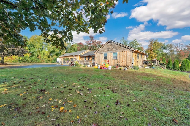 view of front of home with a front lawn and a wooden deck