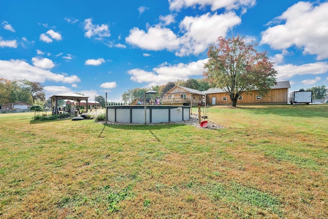 view of yard with an outdoor pool and a gazebo