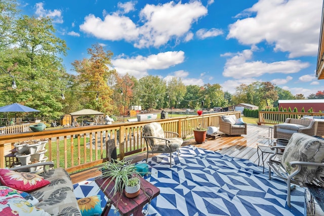 wooden deck with fence, an outdoor hangout area, and a gazebo