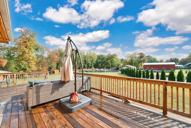 wooden deck featuring a lawn