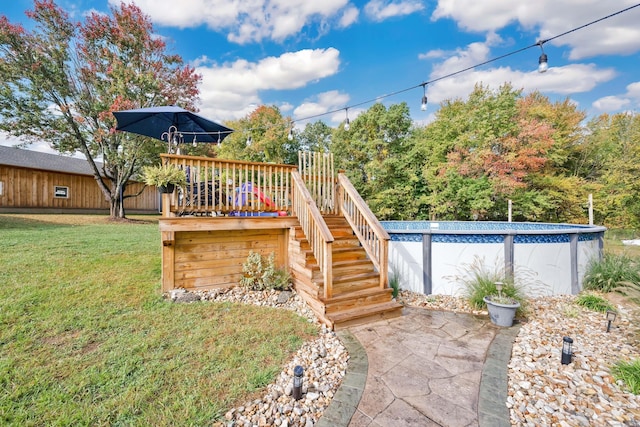 outdoor pool featuring stairway and a lawn