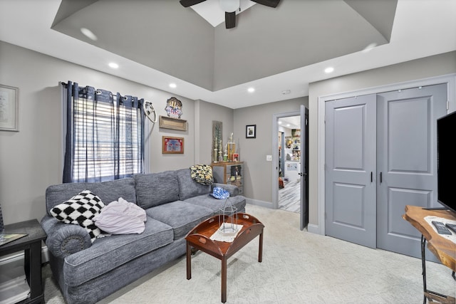 living area with recessed lighting, light colored carpet, vaulted ceiling, ceiling fan, and baseboards