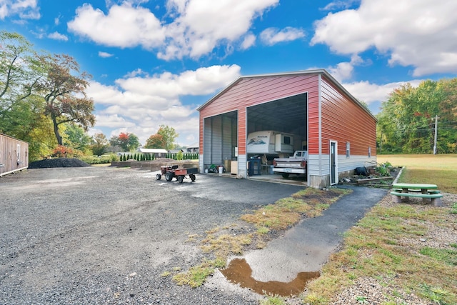 view of vehicle parking with driveway and a carport