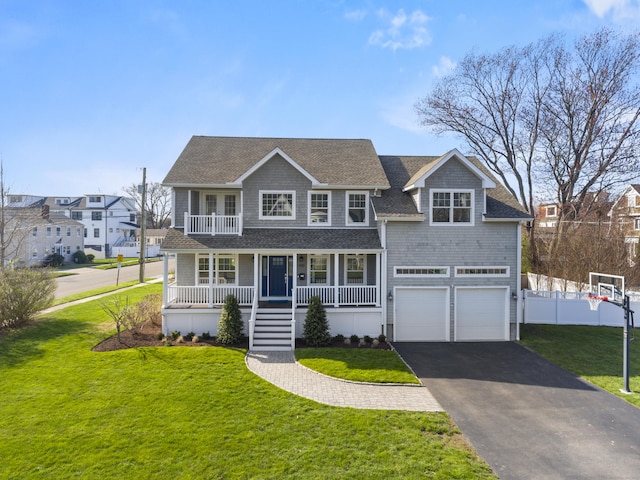 view of front of property featuring a porch, an attached garage, asphalt driveway, and roof with shingles