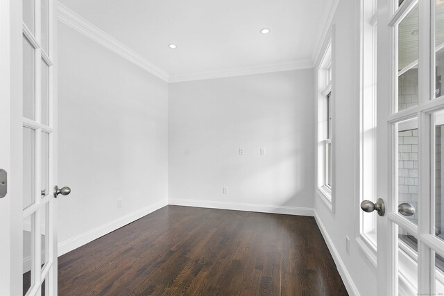 spare room featuring dark wood-style floors, ornamental molding, baseboards, recessed lighting, and french doors