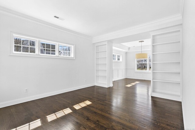 unfurnished living room with healthy amount of natural light, crown molding, built in features, dark wood finished floors, and baseboards