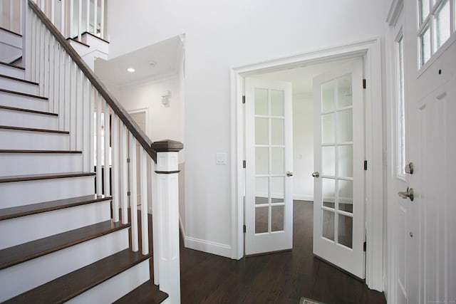 stairs featuring wood finished floors, baseboards, and french doors