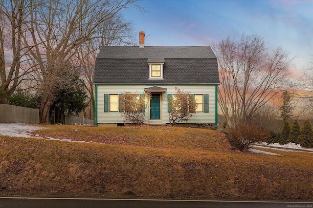 dutch colonial featuring roof with shingles, a gambrel roof, fence, and a chimney