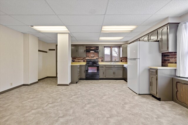 kitchen featuring gray cabinets, light countertops, freestanding refrigerator, dishwasher, and black range with electric stovetop