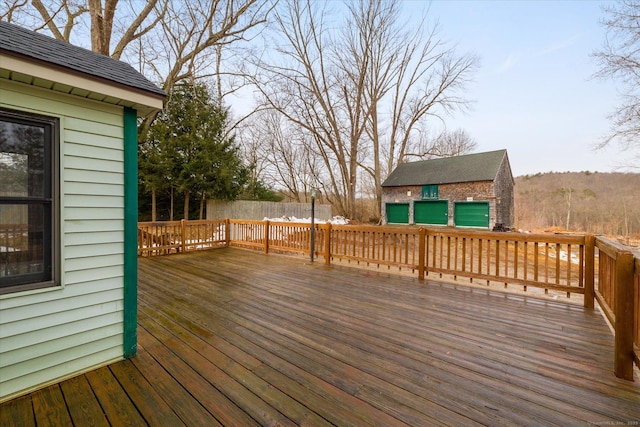 deck featuring an outbuilding and fence