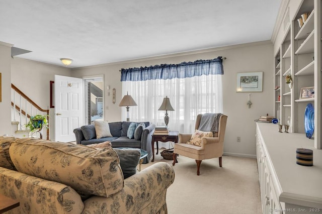 living area featuring light carpet, ornamental molding, stairs, and baseboards